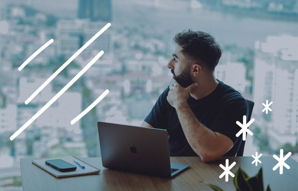 Person sitting at a desk with a laptop, looking out over a city view, with simple graphic lines and star shapes overlayed.