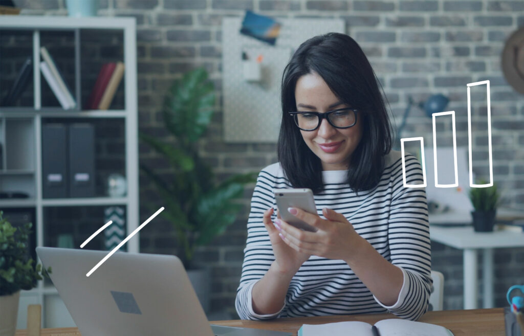 Woman smiling and using a smartphone