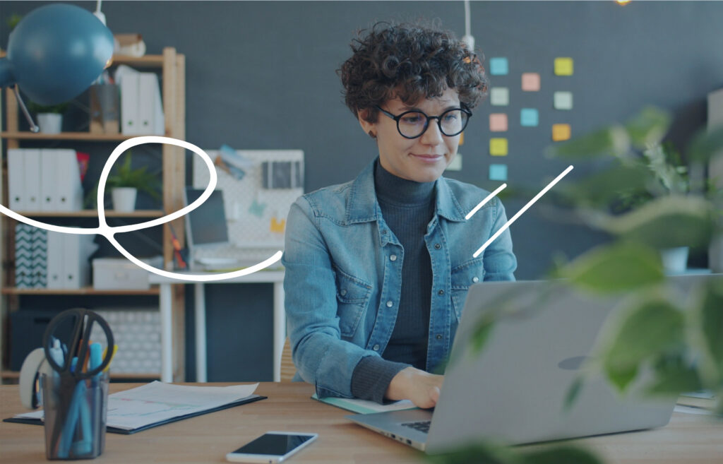 Person working on a laptop at a desk